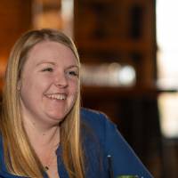 Alumni smiling will talking with someone off camera